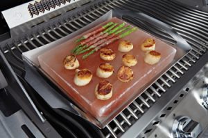 Shrimp and asparagus cooking on a grill topper
