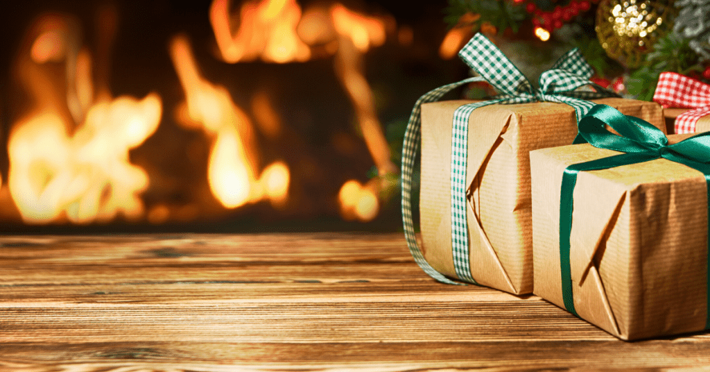 Wrapped Christmas presents with a fireplace in the background