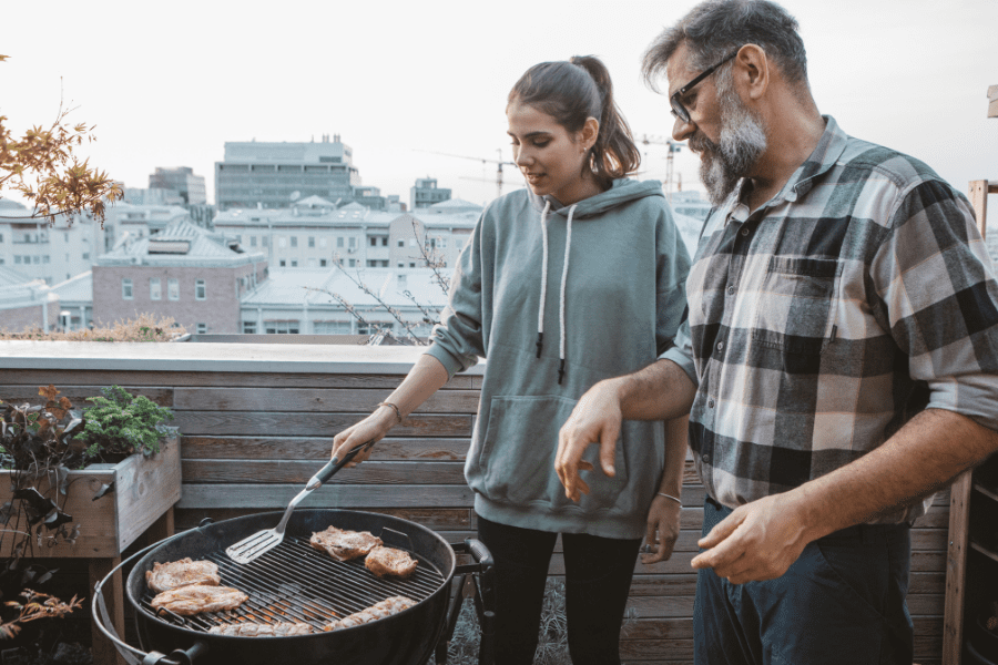couple barbecuing in their outdoor space.