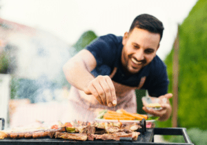 Man grilling food in his outdoor kitchen in backyard