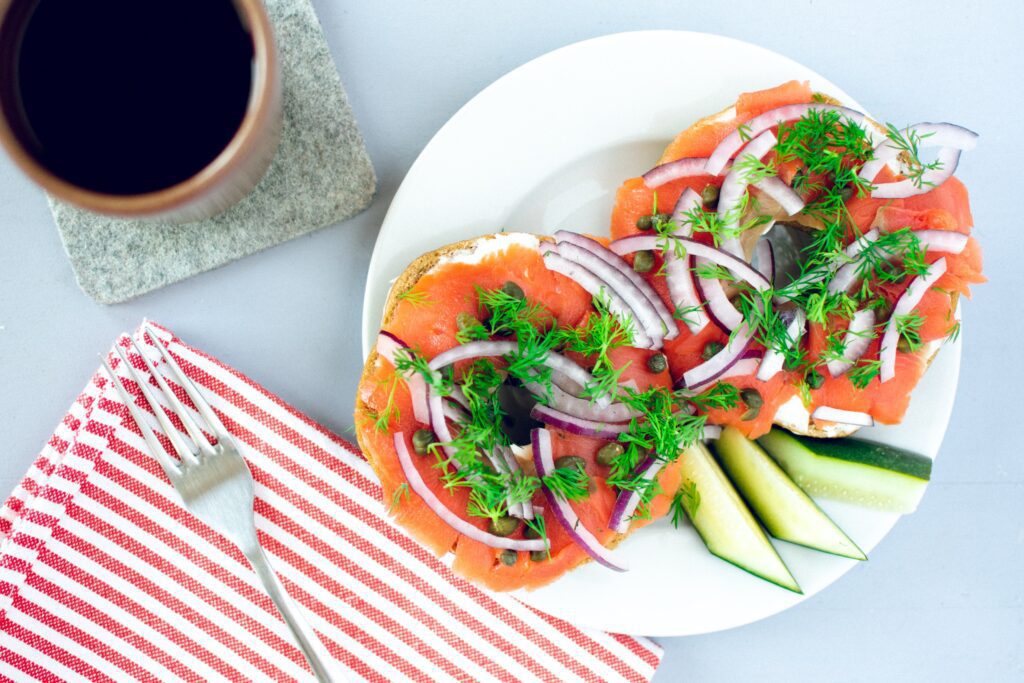Smoked salmon on a bagel with coffee. 
