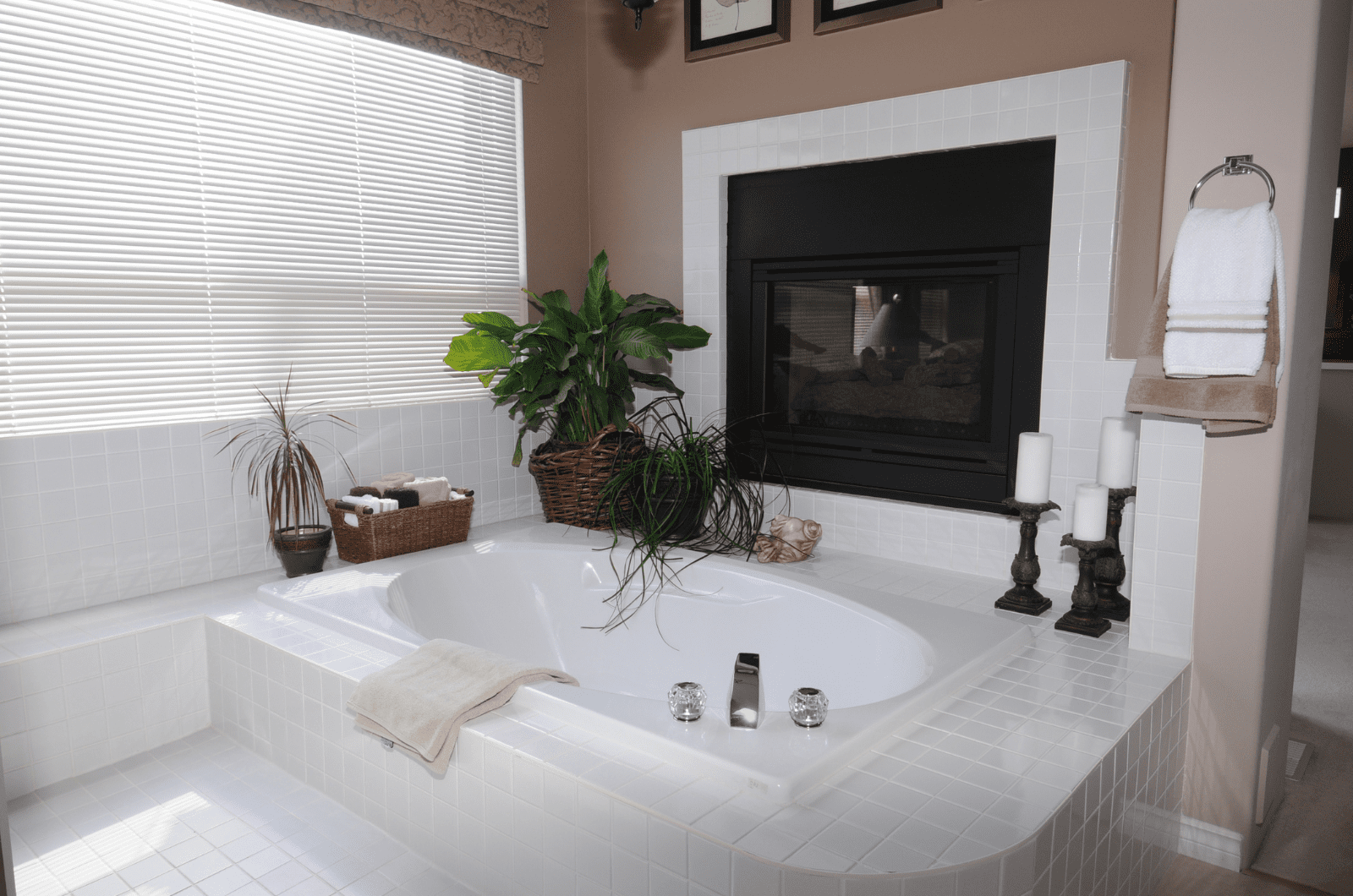 Fireplace next to a tub in a bathroom.