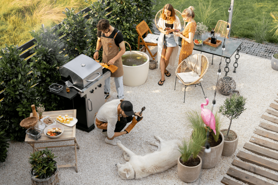 Friends gathering around a grill enjoying the day