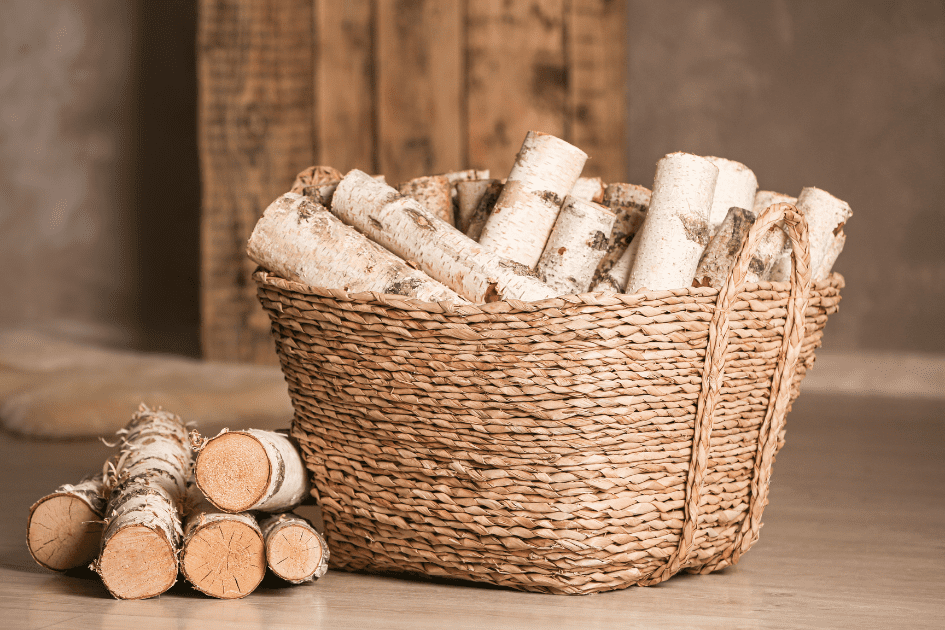 Woven basket repurposed to hold firewood