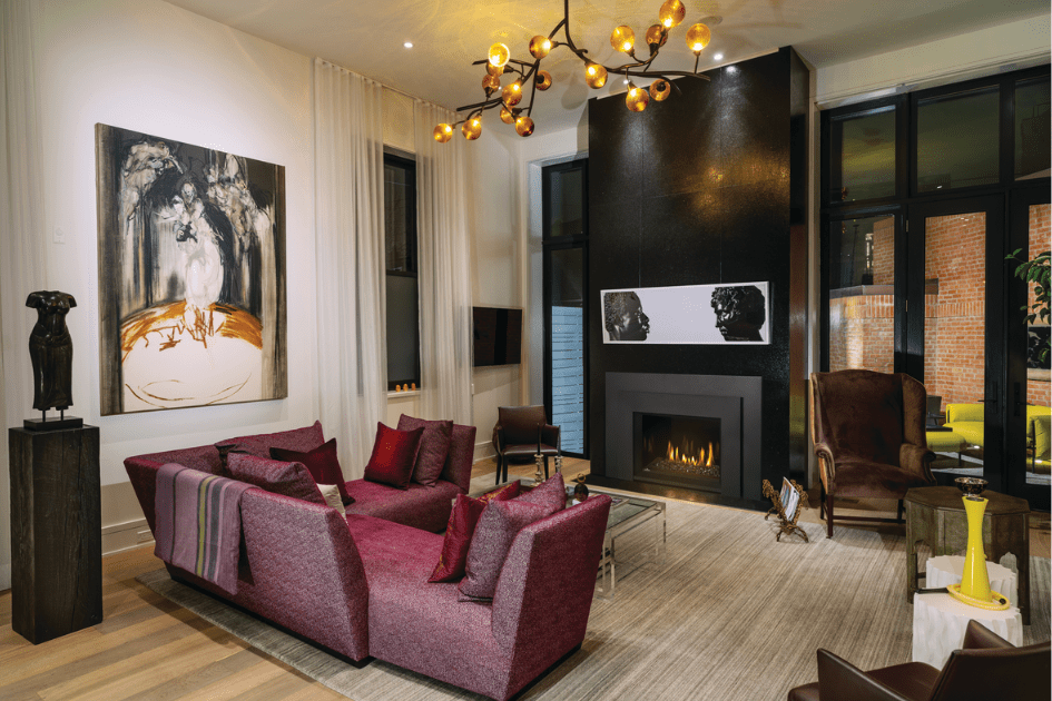 A gas fireplace insert in a living room with modern art and design surrounding it