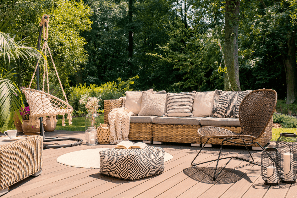 Eclectic boho styled backyard patio set with a mix and match of different wicker patio chairs and a couch.  
